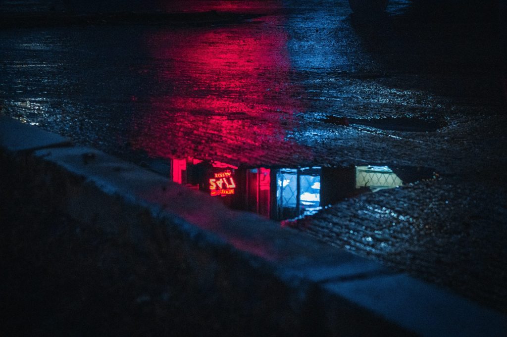pool of water on concrete pavement at night