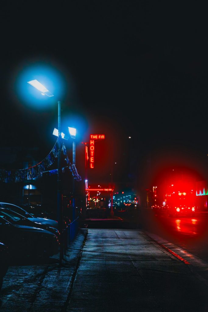 a street with cars and buildings at night