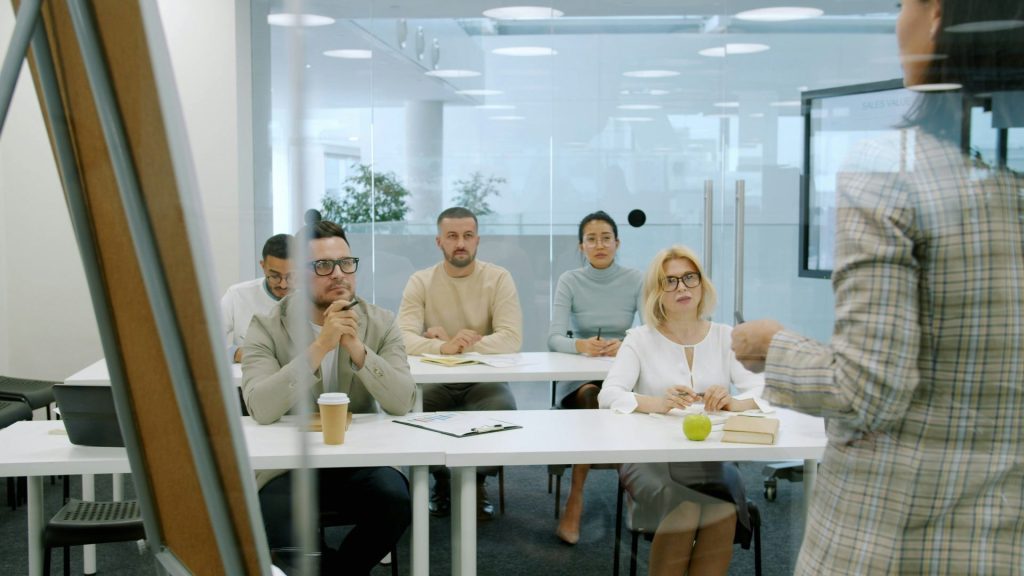 Business people attending a presentation in a modern office.